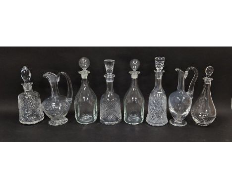 Collection of decanters and claret jugs including a St Louis claret jug, a pair of kicked-in style with globular stoppers, a 