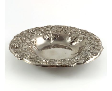 An Art Nouveau silver plated dish, embossed with floral sprigs within a foliate rim, 28.5cm diameter