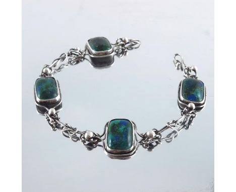 An Arts and Crafts silver and enamelled bracelet, the four alternating rectangular plaques, in blue green and gold enamel, un