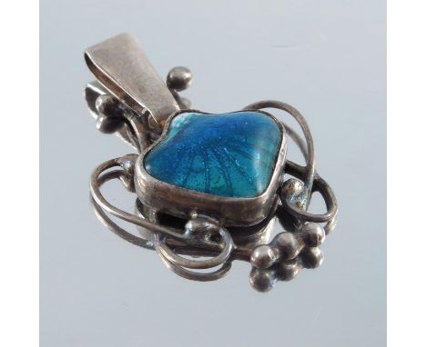 Newlyn School, an Arts and Crafts silver and enamelled pendant, the central shell form cabochon in blue turquoise basse taill