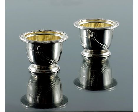 Paul Storr, a pair of William IV silver salt cellars, London 1837, footed beaker form with fluted and reeded wrythen flame mo
