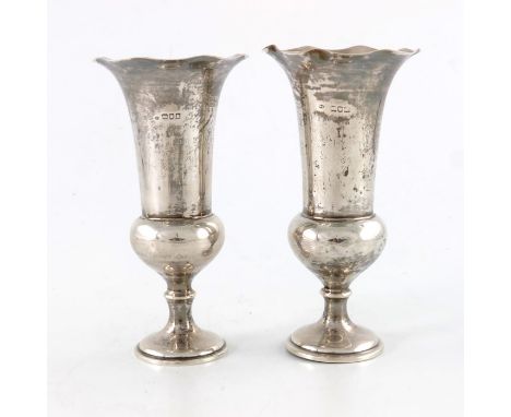 A pair of Edwardian silver pedestal vases, William Comyns, London 1905, Campana urn form with crimped rims, weighted, 18cm hi