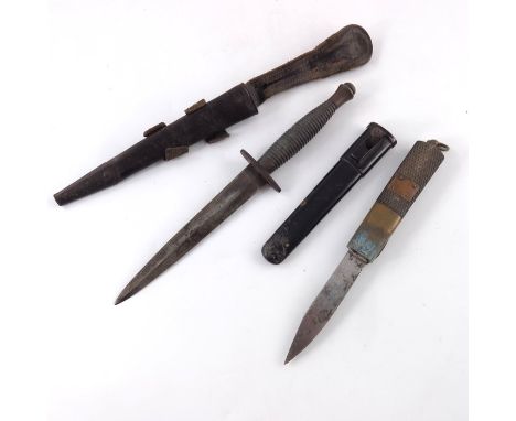 A Fairbain-Sykes style commando knife, in leather scabbard, crosspiece with broad arrow and 11 mark, pommel with 2 mark, 17cm