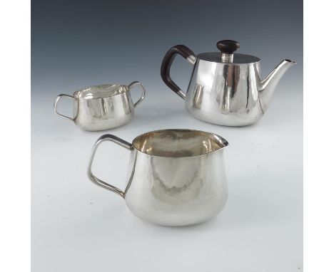 Robert Welch, a Modernist silver three piece tea set, Birmingham 1971, hand hammered ovoid pear form, the teapot with hardwoo