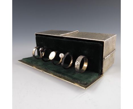 Stuart Devlin, a novelty silver gilt surprise box, London 1974, modelled as a Christmas parcel with ribbon and bow, opening t