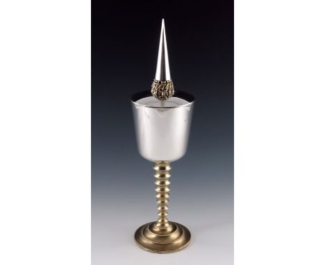 Stuart Devlin, a Modernist silver and parcel gilt chalice and cover, London 1973, the rounded conical cup supported on a text