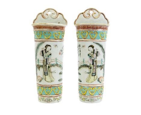 A pair of Chinese wall pockets, sheath form, painted with women in garden and verses, between relief moulded ruyi head border