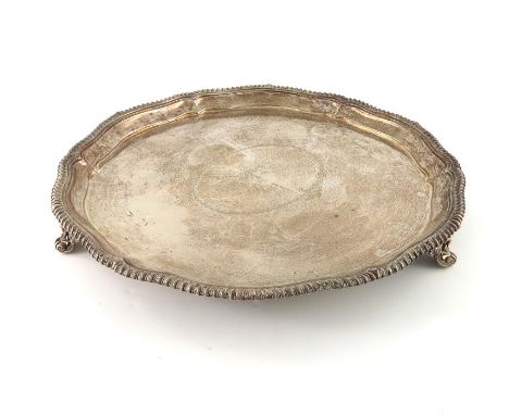 A large Victorian silver salver tray, Elkington and Co., Birmingham 1893, circular form with gadrooned ogee border, on three 