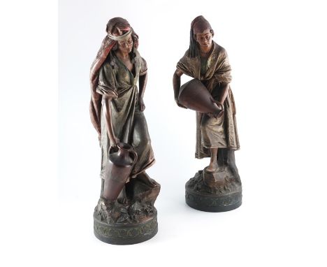 A pair of large Continental terracotta figures of water carriers, in the Goldscheider, Austrian style, modelled in Arabic cos