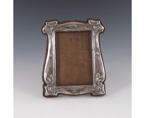 An Arts and Crafts silver photo frame, J Aitkin and Son, Birmingham 1904, ogee baluster form, embossed with flowering vines i