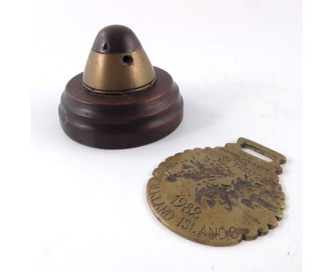 First World War German shell fuze head, 1914, marked 'KZ14 O EEC 15 339', on wooden circular base, together with a commemorat