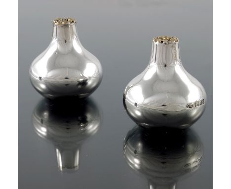 Stuart Devlin, a pair of Modernist silver and parcel gilt salt and pepper pots, London 1976, bulbous onion form, the flat top