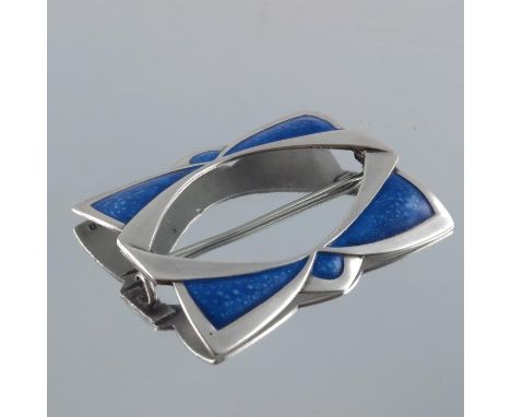 An Arts and Crafts silver and enamelled brooch, JW, Birmingham 1910, in the form of a buckle in blue enamel, folded bow type 