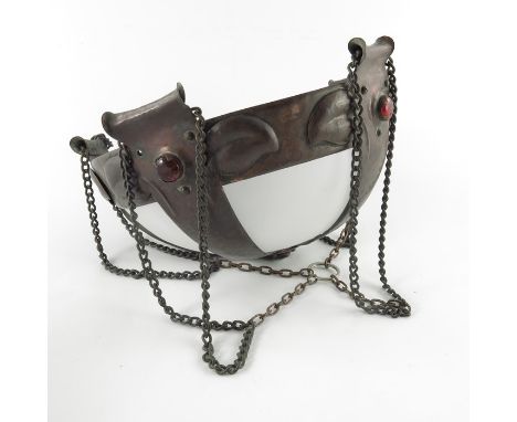 An Arts and Crafts copper and glass pendant light fitting, the hemispherical frosted shade supported within a five strap cage