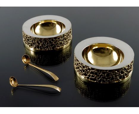 Stuart Devlin, a pair of Modernist silver and parcel gilt salt cellars with spoons, London 1969, squat cylindrical form, the 