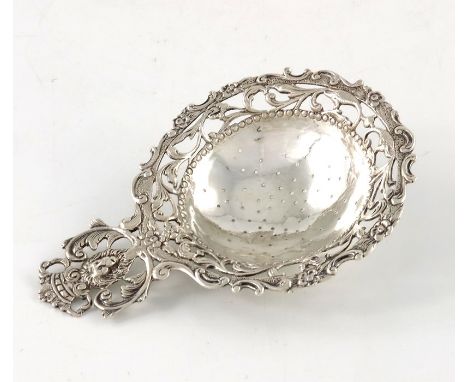 An Edwardian Dutch silver tea strainer, Bethold Muller, Chester import 1906, cast and reticulated foliate scroll design with 