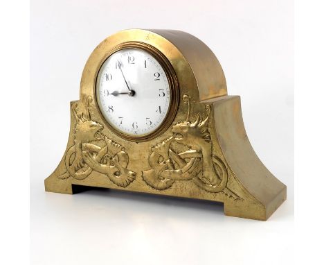 An Arts and Crafts brass clock, domed and splayed bracket form, repousse decorated in the Iona style with knotted zomorphic s