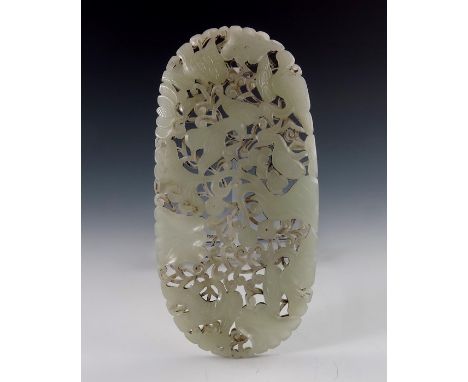 A Chinese carved jade plaque, reticulated and modelled in relief with birds amongst scrolling foliage, 18cm long