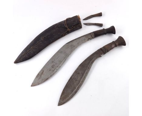 Two Gurkha Kukri knives, one in black leather scabbard and with smaller knives (2)