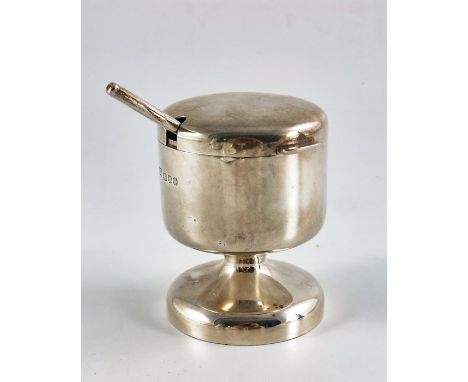 Robert Welch, a Modernist silver mustard pot and spoon, London 1975, cylindrical pedestal form with hinged lid and glass line