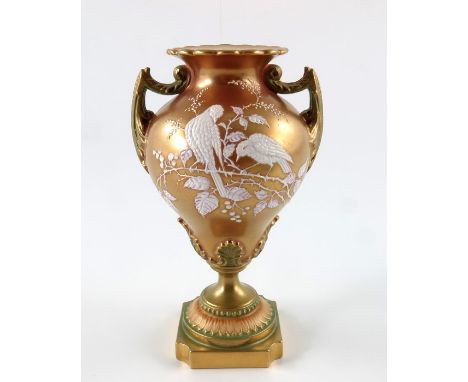 A Royal Worcester pate sur pate and tri colour gilt pedestal vase, 1898, twin handled ogee pear shaped urn form, the blush gi