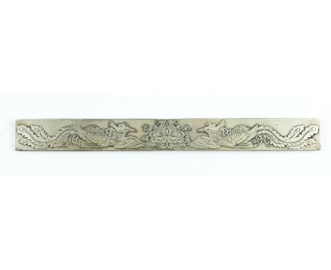 A Chinese silver ingot, rectangular form, cast with phoenix birds flanking a lotus flower, stamped marks, 23cm long, 4.48ozt