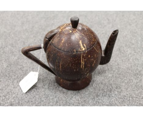 A carved cocunut in the form of a teapot, height 16.5 cm. CONDITION REPORT: An unusual item in good condition, twentieth cent