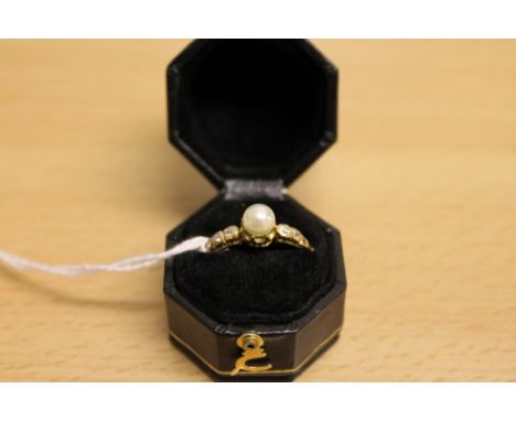 A pearl and diamond ring mounted in yellow metal.