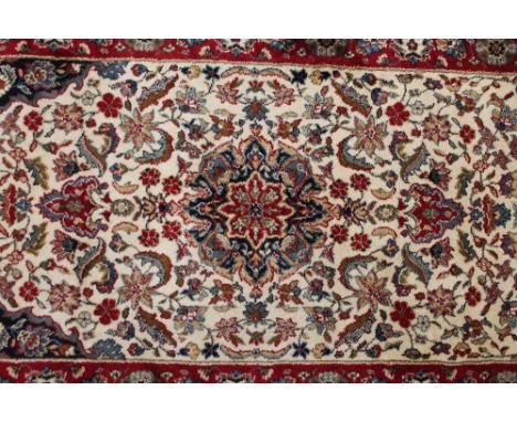 A Kashmir fringed carpet runner on cream and red ground, 235 cm x 68 cm.