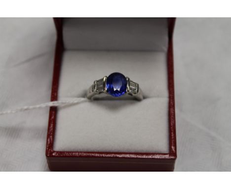 An 18ct white gold two stone diamond and sapphire ring.