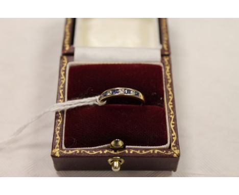 An 18ct gold diamond and sapphire half eternity ring. CONDITION REPORT: Good condition.