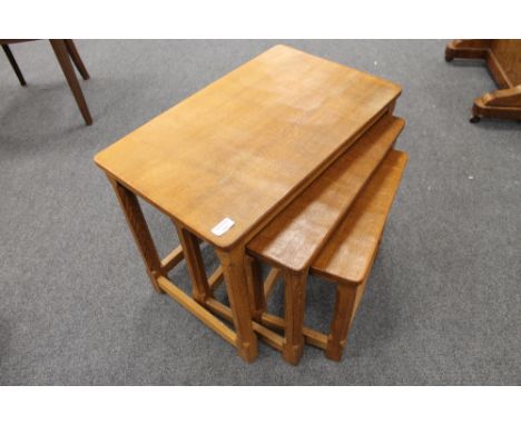A nest of oak tables by Robert 'Mouseman' Thompson of Kilburn, width 61cm.