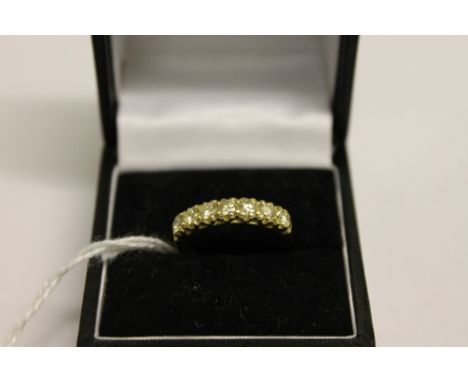 An 18ct gold seven stone diamond ring, approximately 0.85ct.