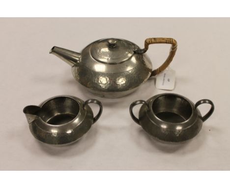 A three piece Tudric pewter tea service. (3) CONDITION REPORT: Good condition, the base numbered 01537.
