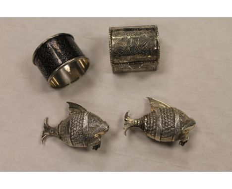 A pair of continental white metal salts modelled as fish, together with a niello napkin ring and miniature white metal casket