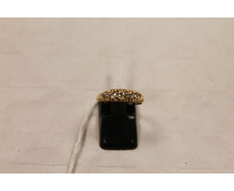 An 18ct gold five stone diamond ring. CONDITION REPORT: Old cut stones with some visible inclusions, condition otherwise time