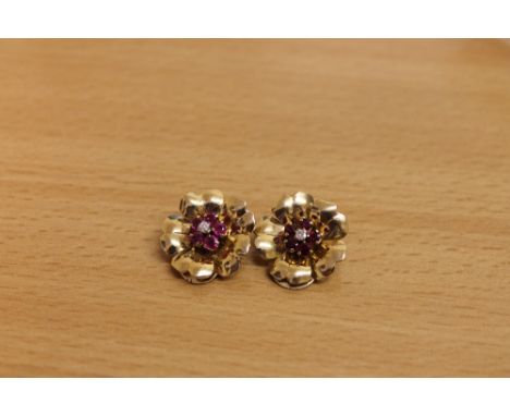 A pair of ruby and diamond earrings, modelled as flowers. (2)