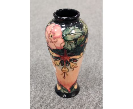 A Moorcroft pottery vase decorated with tubelined flowers on peach ground, height 21 cm. CONDITION REPORT: Good condition, th