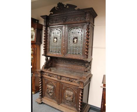 A late Victorian carved oak hunting cabinet, width 134 cm.