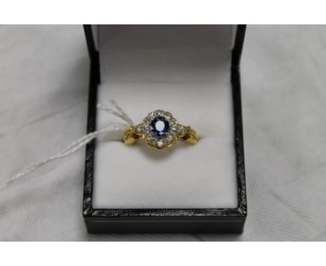 An 18ct gold diamond and sapphire cluster ring.