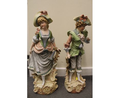 A pair of late nineteenth / early twentieth century continental bisque figures in period costume, inscised markings and numbe