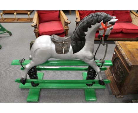 A painted wooden rocking horse, height 105 cm. CONDITION REPORT: Probably early twentieth century, with later paint.