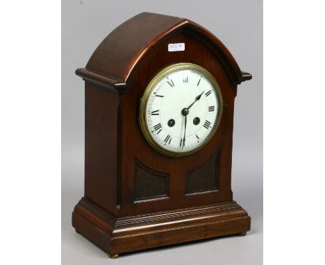 A mahogany cased eight day arch top mantel clock with white enamel dial Roman numeral baton markers chiming on a coiled gong 