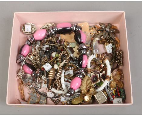 A box of costume jewellery including brooches, bangles, necklaces etc.