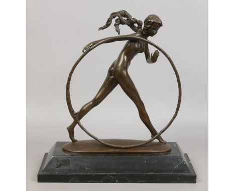 A bronze model in Art Deco style depicting a nude female with hoop raised on stepped marble plinth, 42cm tall.