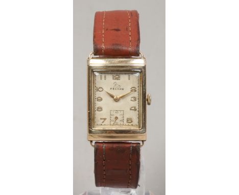 A gentlemans 9ct gold cased record manual wristwatch with rectangular dial having applied gold numerals and subsidiary second