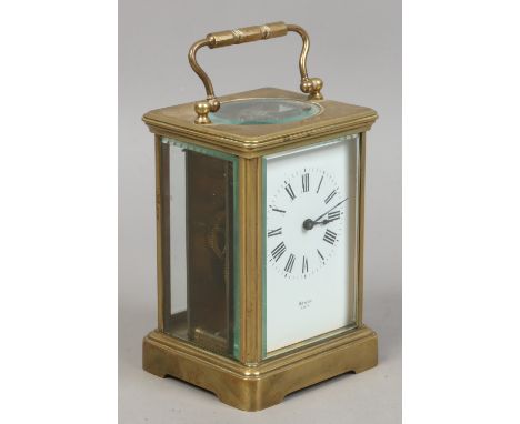 An Oswin Paris brass and glass carriage clock with key.