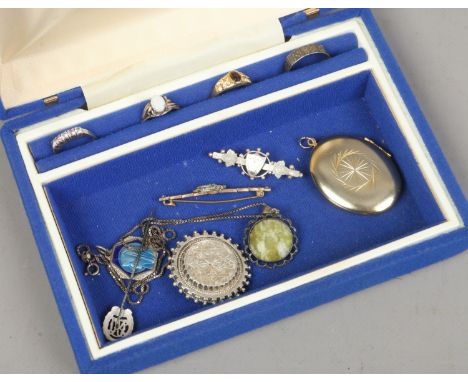 A jewellery box and contents of costume jewellery to include silver examples.