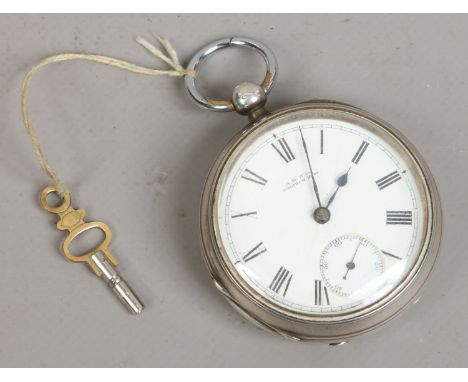 A Victorian silver Waltham pocket watch with white enamel dial subsidiary seconds and Roman numeral markers.