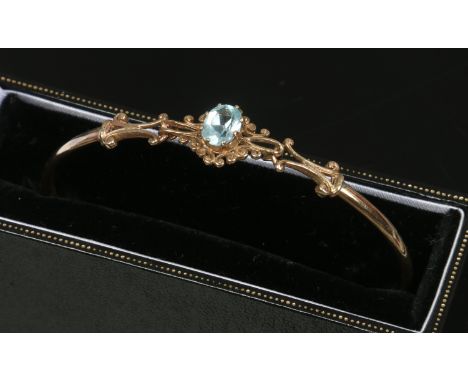 A cased yellow metal blue quartz bangle.